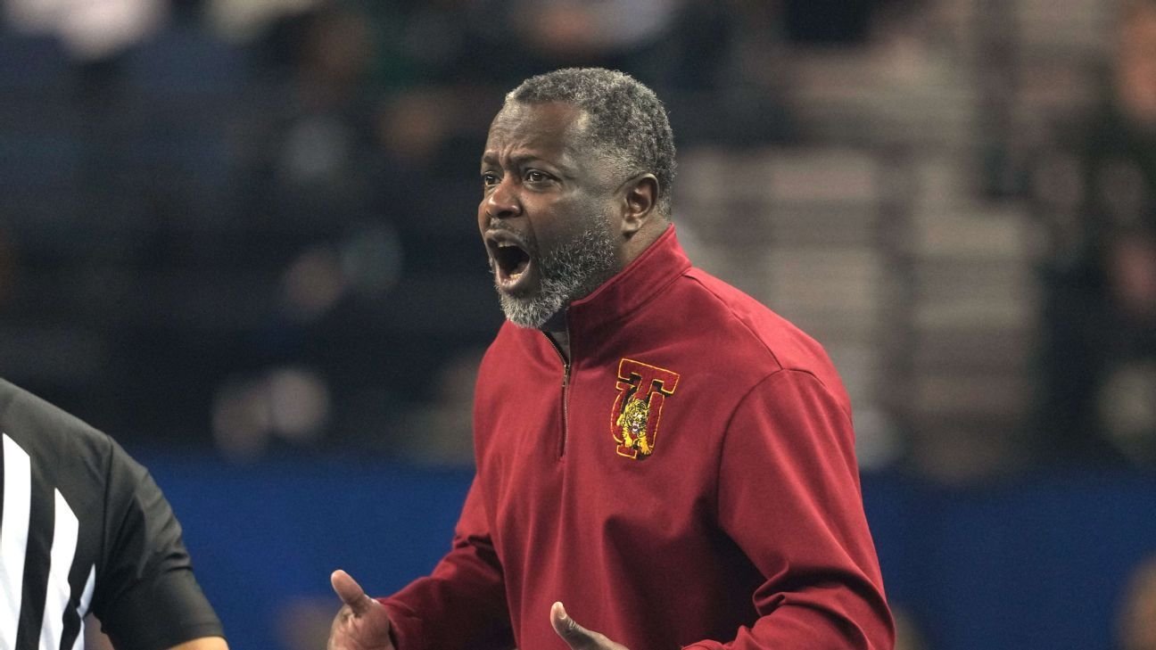 Tuskegee basketball coach Benjy Taylor led off court in handcuffs